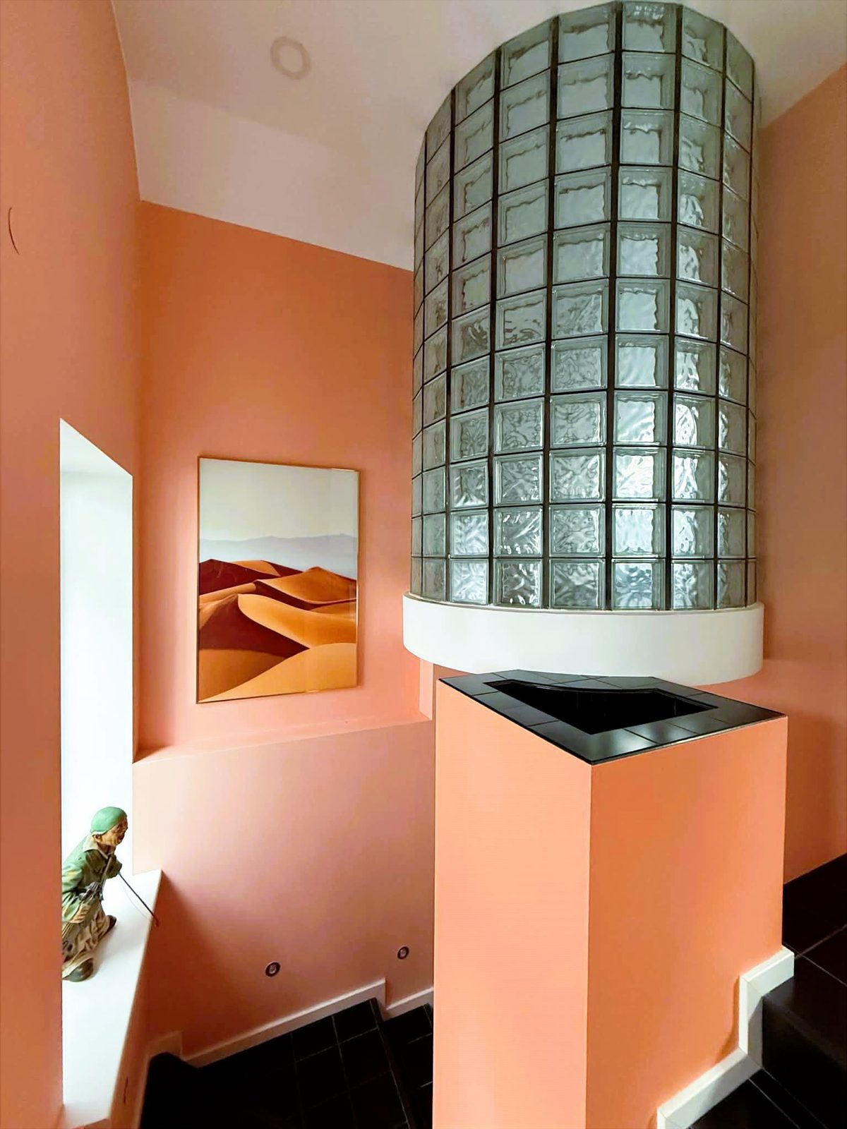 Glass-brick shower above the staircase pillar